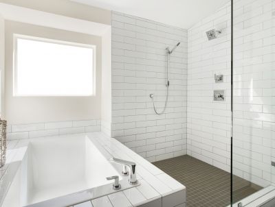 Open-concept shower with large tiles